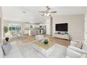 Open-concept living area featuring modern decor and a seamless flow into the dining and kitchen spaces at 9250 Sw 197Th Cir, Dunnellon, FL 34432