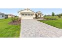 Beautiful single-story home with well-maintained lawn, a paver driveway, and simple landscaping at 9871 Sw 105Th Ct, Ocala, FL 34481