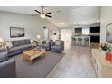 Spacious living room with tile floors, ceiling fan, and views into the kitchen at 9983 Sw 188Th Cir, Dunnellon, FL 34432