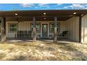 Inviting covered front porch with a swing, ceiling fan and comfortable seating at 11806 Sw 61St Place Rd, Ocala, FL 34481