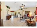 Open-concept living area with tile flooring, comfortable sofas, and stylish decor at 12147 Se 173Rd Pl, Summerfield, FL 34491