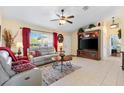 Cozy living room with a comfortable seating area and a ceiling fan for added comfort at 12147 Se 173Rd Pl, Summerfield, FL 34491