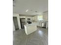 Modern kitchen showcasing white cabinets, stainless steel appliances, and a functional center island at 14173 Se 41St Ter, Summerfield, FL 34491