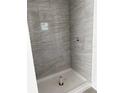 Modern tiled shower with neutral tones and a sleek design, ready for finishing touches at 14173 Se 41St Ter, Summerfield, FL 34491