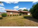 Charming single-story brick home with an attached two-car garage and a well-maintained lawn at 14555 Se 98Th Ave, Summerfield, FL 34491