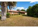 Charming single-story brick home with an attached two-car garage and a well-maintained lawn at 14555 Se 98Th Ave, Summerfield, FL 34491