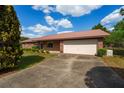 Charming single-story brick home with an attached two-car garage and a well-maintained lawn at 14555 Se 98Th Ave, Summerfield, FL 34491