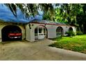 View of the home's exterior with its enclosed pool area and arched entryways at 16850 Se 19Th Ct, Summerfield, FL 34491