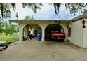 Exterior shot of the home's garage area, featuring arched entryways and a parked truck at 16850 Se 19Th Ct, Summerfield, FL 34491