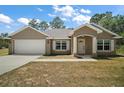 Charming single-Gathering home with a two-car garage, manicured lawn, and well-maintained landscaping at 171 Oak Cir, Ocala, FL 34472