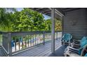 Enjoy a pool view from this covered balcony with blue-cushioned seating at 20820 River Dr # B25, Dunnellon, FL 34431