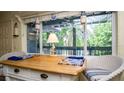 Charming dining area with a large window offering views of the lush greenery outside at 20820 River Dr # B25, Dunnellon, FL 34431