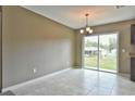 Bright dining area features tile flooring, a chandelier, and sliding glass doors offering views of the outdoors at 22913 Sw Edgewater Blvd, Dunnellon, FL 34431