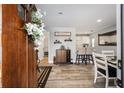 Warm and inviting entryway with a wooden door, leading to the open-concept dining and kitchen area at 3250 Sw 46Th Ave, Ocala, FL 34474