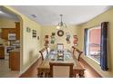 Inviting dining room with hardwood floors, a window, and a stylish chandelier above the dining table at 3792 Sw 152Nd Ct, Ocala, FL 34481
