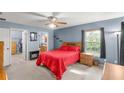 Comfortable main bedroom featuring a ceiling fan, ensuite bathroom, and a walk-in closet at 3792 Sw 152Nd Ct, Ocala, FL 34481