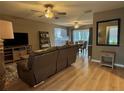 Open-concept living room with wood floors, neutral walls, ceiling fans, and view to dining area at 4513 Nw 30Th Pl, Ocala, FL 34482