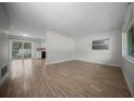 Bright living room with wood-look tile flooring, neutral walls and sliding doors at 511 Se 29Th Ter, Ocala, FL 34471