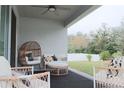 Cozy covered patio area featuring stylish furniture, perfect for enjoying the outdoors in comfort at 5515 Se 91St St, Ocala, FL 34480