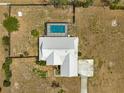 Aerial view of a well maintained single-story home with a screened-in pool and spacious backyard at 6045 Se 99Th Pl, Belleview, FL 34420
