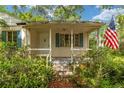 A classic front porch with American flag, perfect for relaxing and enjoying the neighborhood at 608 Se 31St Ter, Ocala, FL 34471