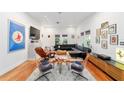 Open-concept living room with hardwood floors, unique artwork, and modern furniture at 716 Se Wenona Ave, Ocala, FL 34471