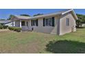 A single story home with siding and green shutters on a sunny day at 8443 Sw 109Th Place, Ocala, FL 34481