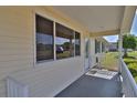 A porch is shown featuring a full railing and entrance to the home at 8443 Sw 109Th Place, Ocala, FL 34481