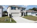 Charming two-story house with a well-maintained lawn and a paved driveway at 8617 Triumph Cir, Wildwood, FL 34785