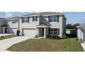 Beautiful two-story home with a spacious front yard and a two-car garage at 8617 Triumph Cir, Wildwood, FL 34785
