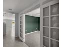 Office space featuring neutral walls, carpet flooring, and glass french doors at 8617 Triumph Cir, Wildwood, FL 34785