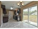 The kitchen is complete with stainless steel appliances, dark cabinets, and a sliding glass door to the backyard at 89 Fisher Way Crse, Ocklawaha, FL 32179