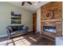 Cozy living room with a wood-paneled fireplace, modern furnishings, and hardwood flooring at 8950 Se 17Th Ct, Ocala, FL 34480