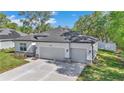 Stylish single-story home with a two-car garage, modern finishes, and a well-maintained front yard at 9405 Se 159Th Ln, Summerfield, FL 34491