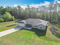 Wide aerial shot showcasing a charming home and its large yard nestled among beautiful mature trees at 9525 Sw 200 Ct, Dunnellon, FL 34431