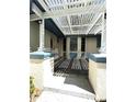 Covered entry with architectural details providing shade and style to the home at 9711 Sw 196Th Cir, Dunnellon, FL 34432