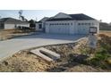 Charming single-story home featuring a spacious three-car garage and a concrete driveway at 10409 Sw 45 St, Ocala, FL 34481
