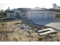 Beautiful single-story home featuring a three-car garage and concrete driveway at 10409 Sw 45 St, Ocala, FL 34481
