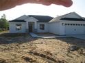 Inviting single-story home with a three-car garage and stone accents at 10409 Sw 45 St, Ocala, FL 34481