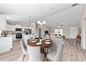 Bright dining area and kitchen with stainless steel appliances and a view into the living room, creating an inviting space at 10426 Sw 133Rd Ave, Dunnellon, FL 34434
