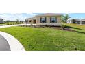 Well-manicured lawn in front of the house, enhancing the curb appeal of this charming residence at 10530 Sw 98Th Pl, Ocala, FL 34481