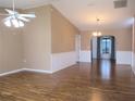 Bright and airy living room featuring fresh paint, wood-look floors, and large archway to dining area at 13816 Sw 112Th Ter, Dunnellon, FL 34432