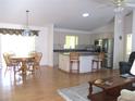 Bright, open-concept kitchen and dining area with stainless steel appliances and hardwood floors at 14272 Sw 112Th Cir, Dunnellon, FL 34432