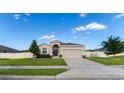 Charming single-story home features a well-manicured lawn, a two car garage, and a lovely front door at 1509 Ne 50Th Ter, Ocala, FL 34470