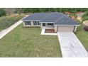 Aerial view of a single-story home with large yard, highlighting its neighborhood setting at 16219 Sw 48Th Cir, Ocala, FL 34473