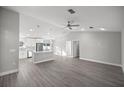 Bright open-concept living and kitchen area with sleek gray flooring and modern lighting fixtures at 20812 Sw Cardinal Ave, Dunnellon, FL 34431