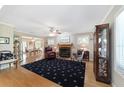 Cozy living room with fireplace, hardwood floors, and ample natural light, perfect for relaxation and entertaining guests at 20921 Sw 36Th St, Dunnellon, FL 34431