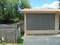 View of the property's exterior, featuring a screened in porch and a wooden fence at 2912 Ne 24Th Ct, Ocala, FL 34479