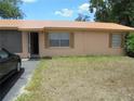 The exterior of a well-kept home featuring a metal roof, two windows with shutters and an open screened in porch at 2912 Ne 24Th Ct, Ocala, FL 34479