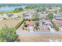 Expansive aerial view of the property, showcasing its location, landscaping, and proximity to a tranquil lake and surrounding area at 347 Oak Lane Dr, Ocala, FL 34472
